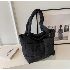 Minimalist black quilted shoulder tote bag with small zipper pouch and fluffy handle