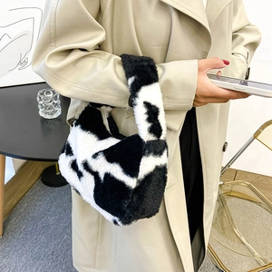 Mini sac à main chic en fausse fourrure motif vache avec poignées en peluche pour mode hiver