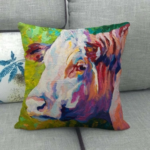 Colorful oil painting cow linen throw pillow cover displayed on a gray fabric sofa
