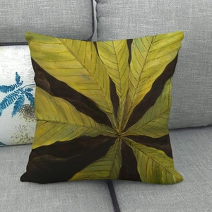 Macro shot of tropical green leaf watercolor print on a durable linen pillow cover