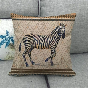 Detail of linen pillow cover featuring a zebra print and ethnic geometric borders
