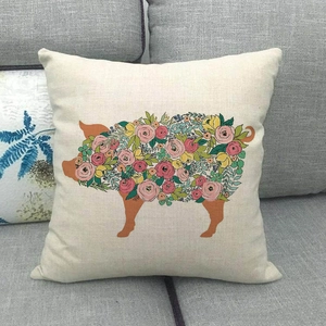Detailed close-up of a rustic linen pillow cover featuring a floral pig silhouette