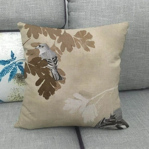 Detail showing the linen texture and oil painting bird print on the square cushion cover
