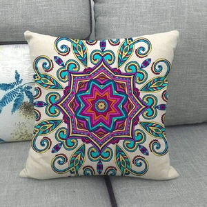 Close-up of linen cushion cover featuring colorful mandala pattern on grey sofa