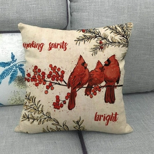Detail of red cardinal birds on linen pillow cover with making spirits bright text