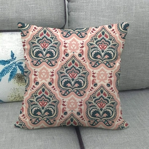 Detail view of ethnic paisley floral patterns on a linen blend throw pillow case