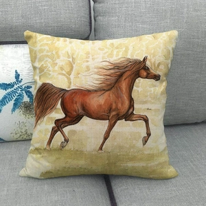 Detail of wild mustang pattern on a linen cushion cover placed on a gray fabric sofa