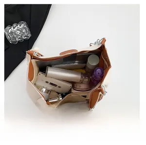 Top view of spacious interior storage of beige tote bag with cosmetics and gadgets