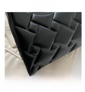 Close-up of black leather bag featuring premium 3D quilted stitching and glossy texture