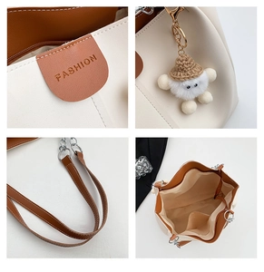 Detail views of cream and brown tote bag showing the fashion logo, plush charm and interior
