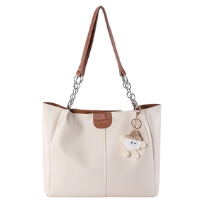 Chic cream tote bag with brown leather handles and a cute plush lamb pendant