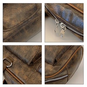 Close-up of vintage brown distressed leather texture and metal hardware on a tote bag