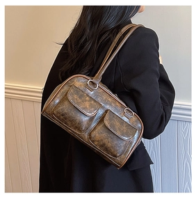 Detail of vintage brown shoulder bag showing retro marble texture and dual front flap pockets