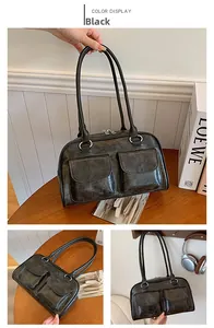 Detail view of black tote bag with dual front pockets and silver ring buckles