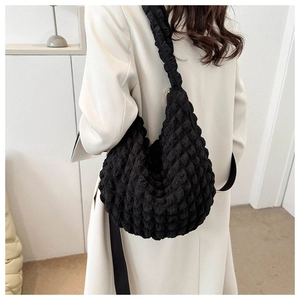 Detail view of black popcorn texture tote bag with soft elastic pleated fabric surface