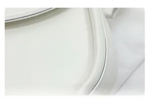 Close-up of precise edge stitching and high-quality white leather texture on handbag