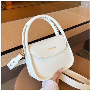 Detail view of white leather crossbody bag with curved top handle and fashion logo