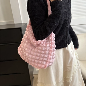 Pink popcorn texture hobo bag with large capacity for women shown in a lifestyle setting