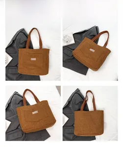 Close-up of brown faux shearling tote bag with Fashion tag and leather shoulder strap