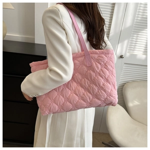 Close-up of pink quilted tote bag with diamond stitching and puffer texture for women