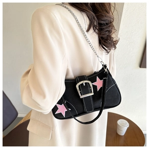 Y2K style black canvas underarm bag featuring pink stars and large silver buckle detail