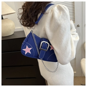 Blue canvas underarm bag featuring pink star patches and silver metal chain detail