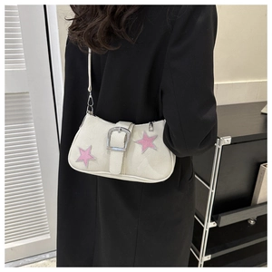 Detail of minimalist cream underarm bag with pink star embroidery and silver buckle