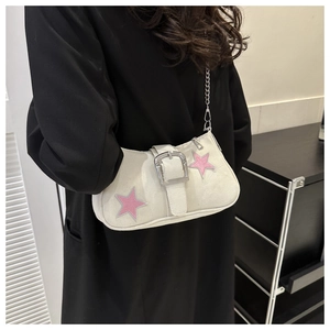 Detail of white star-embossed underarm bag with silver buckle and chain strap