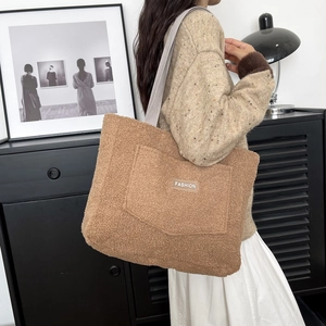 Brown fluffy faux fur tote bag with large front pocket and white FASHION text label