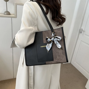 Chic color-block tote bag in brown and black leather with decorative silk scarf