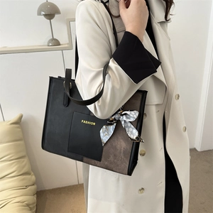 Minimalist bicolor tote bag with scarf detail and fashion print shown on model