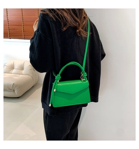 Model wearing bright green leather crossbody bag showing body proportions and style