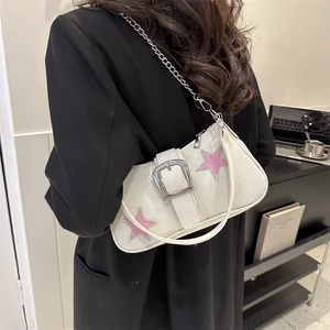 Chic beige canvas underarm bag with metal buckle, star patches, and dual straps