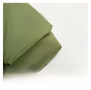 Detailed macro texture of army green durable textile fabric on casual crossbody bag