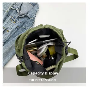 Internal view of green nylon drawstring bag showing large capacity for daily essentials