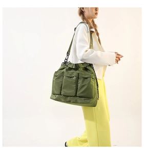 Olive green military style nylon tote bag with utility pockets and chain strap