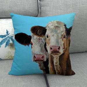 Macro detail of cow oil painting cushion cover on a gray sofa with linen texture