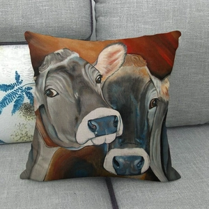 Artistic oil painting cow pattern throw pillow on gray sofa made of textured linen