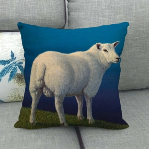 Detailed close-up of a linen cushion cover featuring a white sheep on green grass