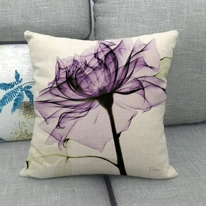 Linen cushion cover featuring purple ink-style floral art on a gray fabric sofa