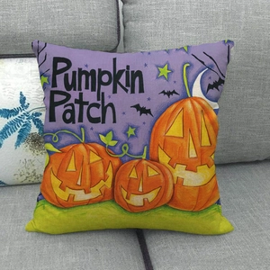 Macro shot of Halloween pumpkin patch print on linen cushion cover leaning on grey sofa