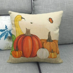 Close-up of linen Halloween pumpkin pillow cover with hand-painted butterfly and bee