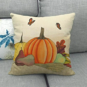 Halloween pumpkin harvest linen pillow cover with leaves and wheat on a sofa