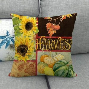 Detail of harvest pumpkin and sunflower print on rustic linen textured square pillow cover