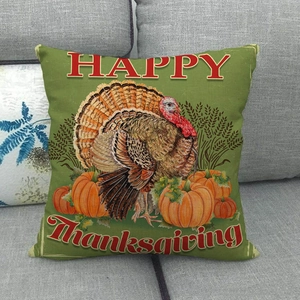 Linen thanksgiving cushion cover with pumpkin and turkey print on a gray sofa