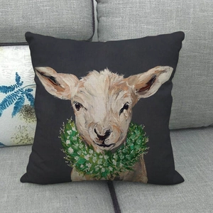Linen throw pillow cover featuring a rustic oil painting of a lamb with floral wreath
