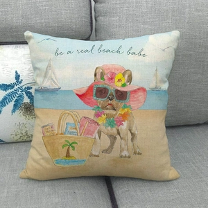 Linen pillow cover with beach dog print and 'be a real beach babe' text on grey sofa