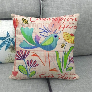 Close-up of bird and flower print on textured linen fabric of a square cushion cover