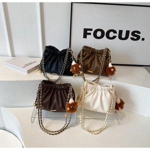 Collection of minimalist pleated cloud bags with chain straps in four neutral colors