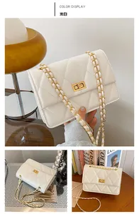 Détail du petit sac bandoulière matelassé blanc crème avec chaîne et fermoir dorés